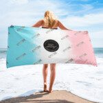 Woman with pastel beach towel facing ocean